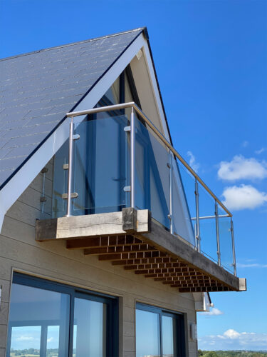 The round steel balustrade looks great from all angles on the balcony of a sea view house at Normans Bay, Eastbourne.