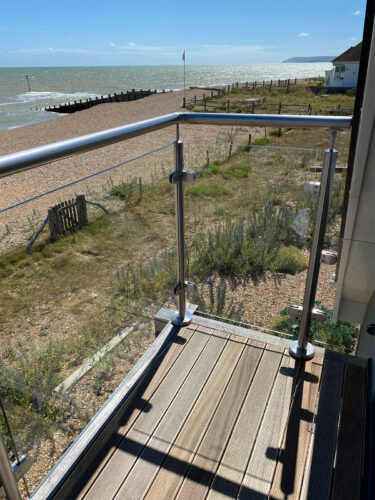 Sea view to the south-west from the composite balcony with a modern steel balustrade with a glazing system in Eastbourne beach.
