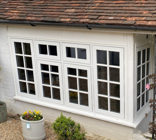 New white flush casement UPVC bay window with astragal bars mounted in house in Hailsham by builders from River.ODP.