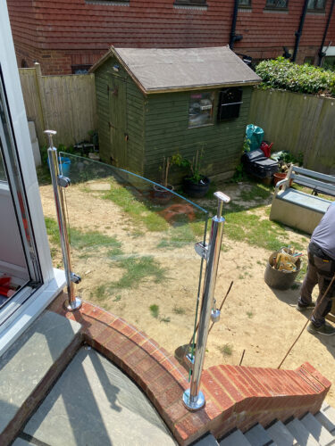 Stainless steel glass balustrade during installation by building company River.ODP in house in Bexhill On The Sea.