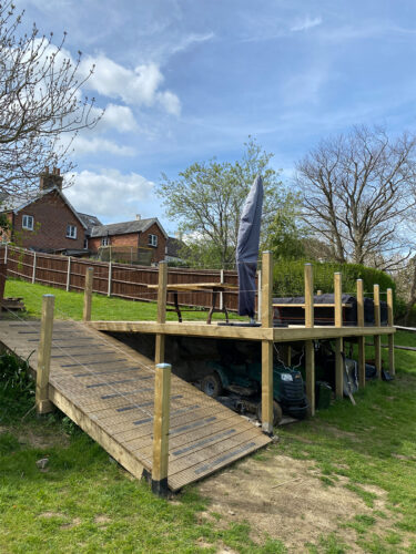 Sunny Wooden decking with timber posts and stainless steel wire rope balustrade built in Banstead by River.ODP installation company.