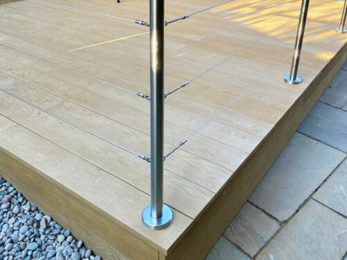 Modern stainless steel balustrade with a wired system installed on composite decking in Hailsham by Installation company River.ODP.