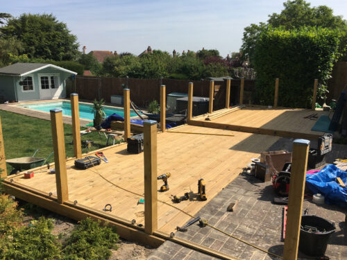 Wood and glass balustrade mounted on large timber decking in Robertsbridge by installation company River.ODP
