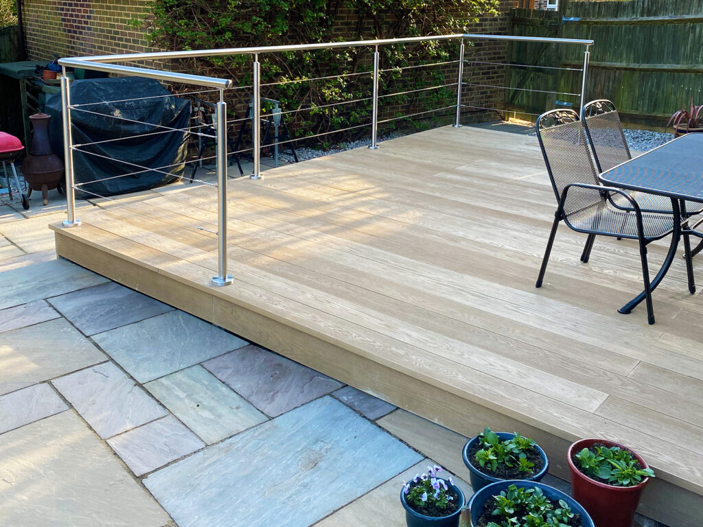 Composite decking with wire stainless steel balustrade installed in Burgess Hill by installation company River.ODP
