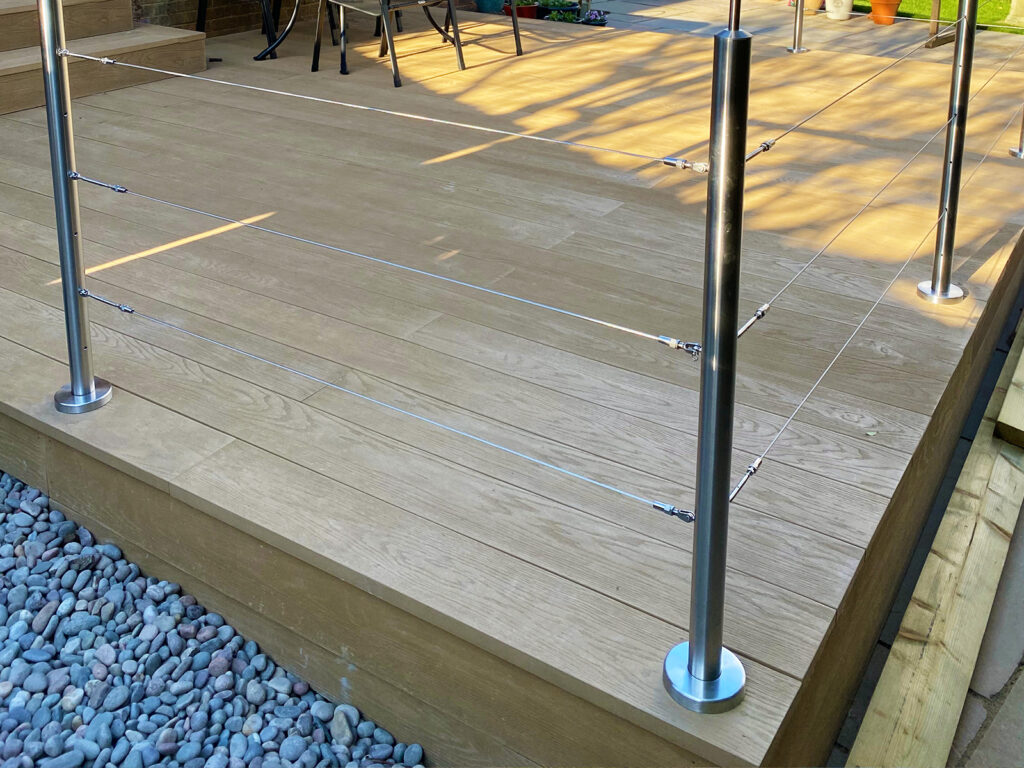 Modern steel balustrade installation with a wired system on composite decking in East Dean by Installation company River.ODP.
