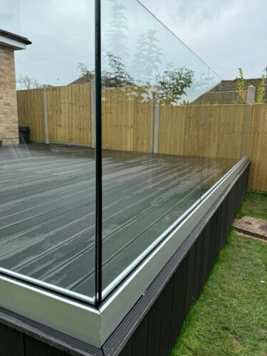 Frameless glass balustrade installation on composite decking in Dartford by building company River.ODP.