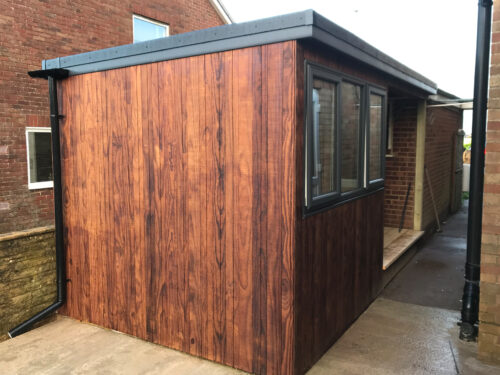 A wooden and insulated garden room/study/office with a sliding patio doors in Hastings East Sussex.
