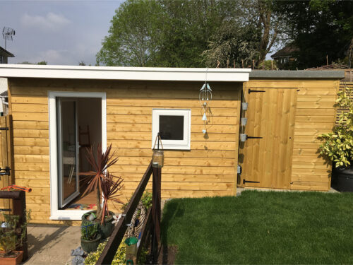 Insulated garden study room with wooden cladding and double UPVC windows built in Tadworth by River.ODP building company.