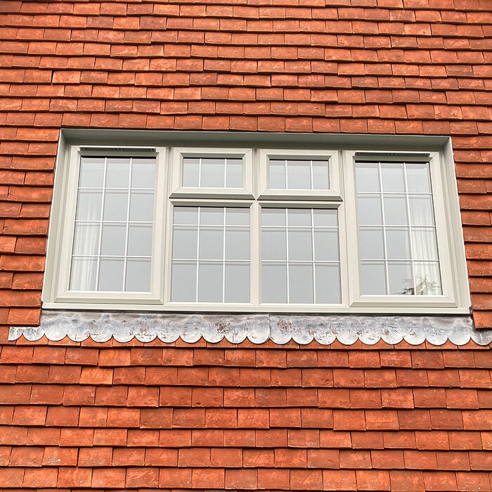 White UPVC Casement large window on tiled wall with astragal bars installed by River.ODP builders in Ewell in Surrey