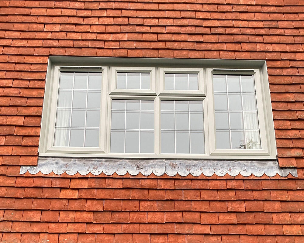 White UPVC Casement large window on tiled wall with astragal bars installed by River.ODP builders in Ewell in Surrey