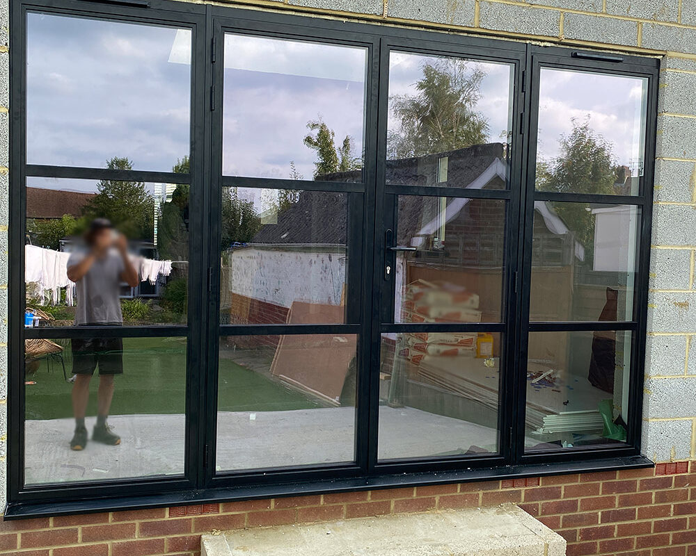 Aluminium French doors with windows on both side in shaker style in the new extension installed by Building company River.ODP