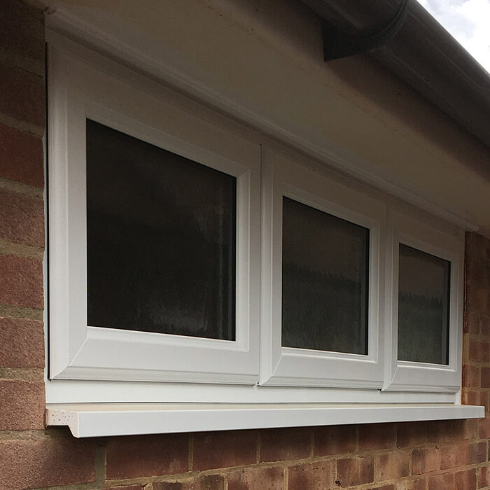White UPVC triple Casement window installed in garage by Building company River.ODP in Epsom in Surrey