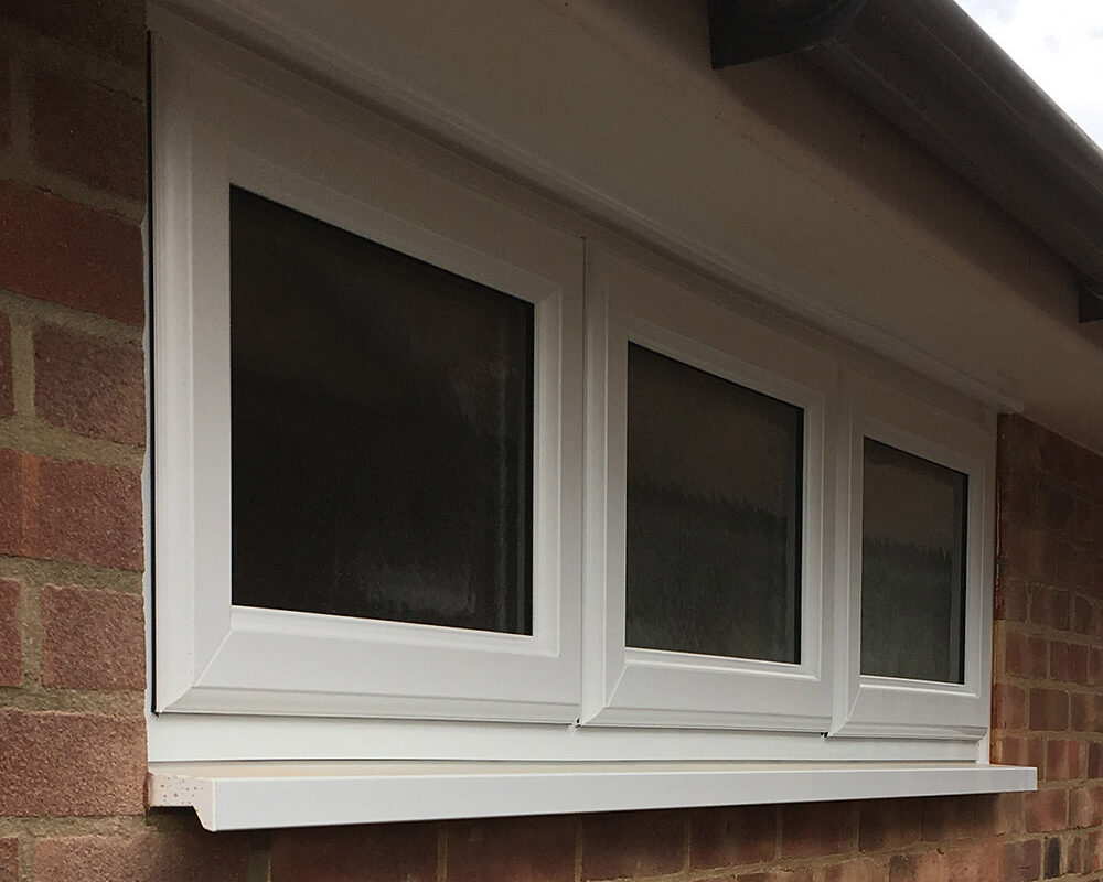 White UPVC triple Casement window installed in garage by Building company River.ODP in Epsom in Surrey