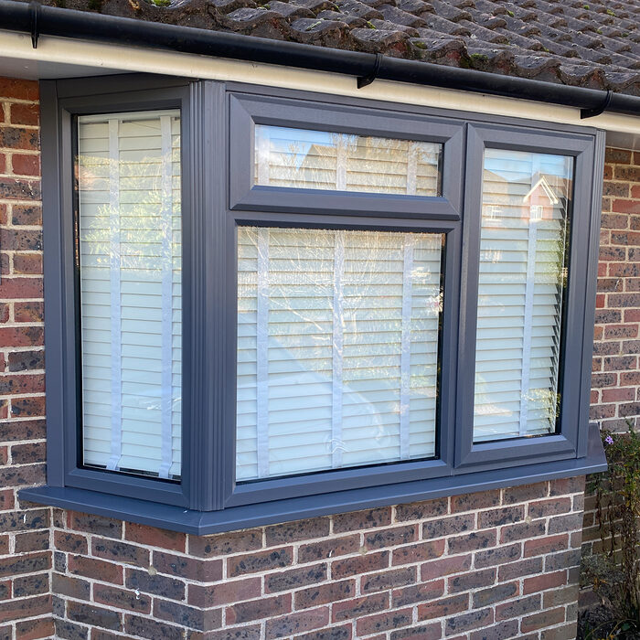 Anthracite UPVC Casement bay window installed by River.ODP builders in brick house in Farnham in Surrey