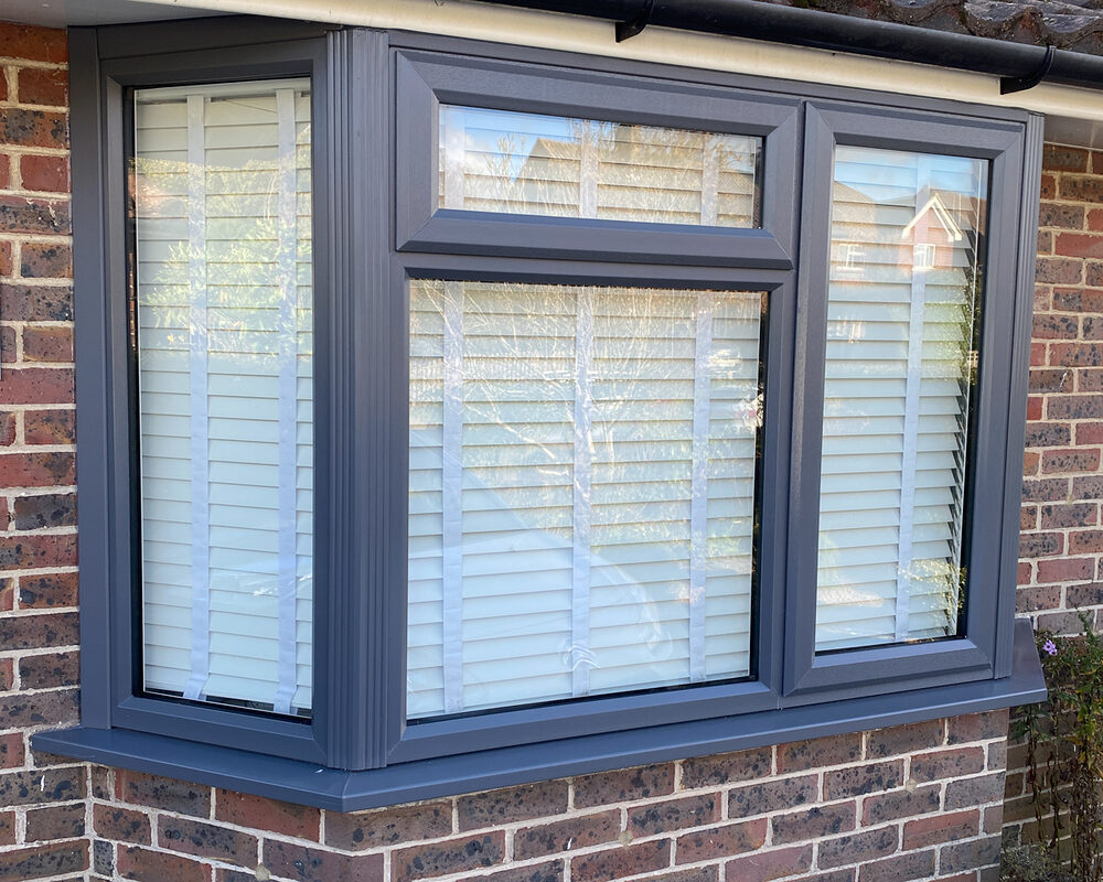 Anthracite UPVC Casement bay window installed by River.ODP builders in brick house in Farnham in Surrey