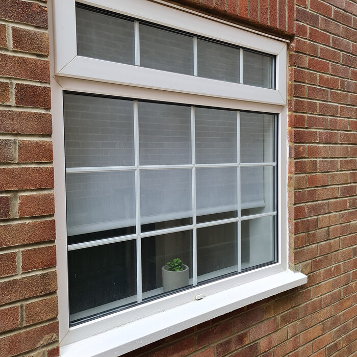 White UPVC Casement window with top leaf & astragal bars installed by River.ODP builders in Frimley in Surrey