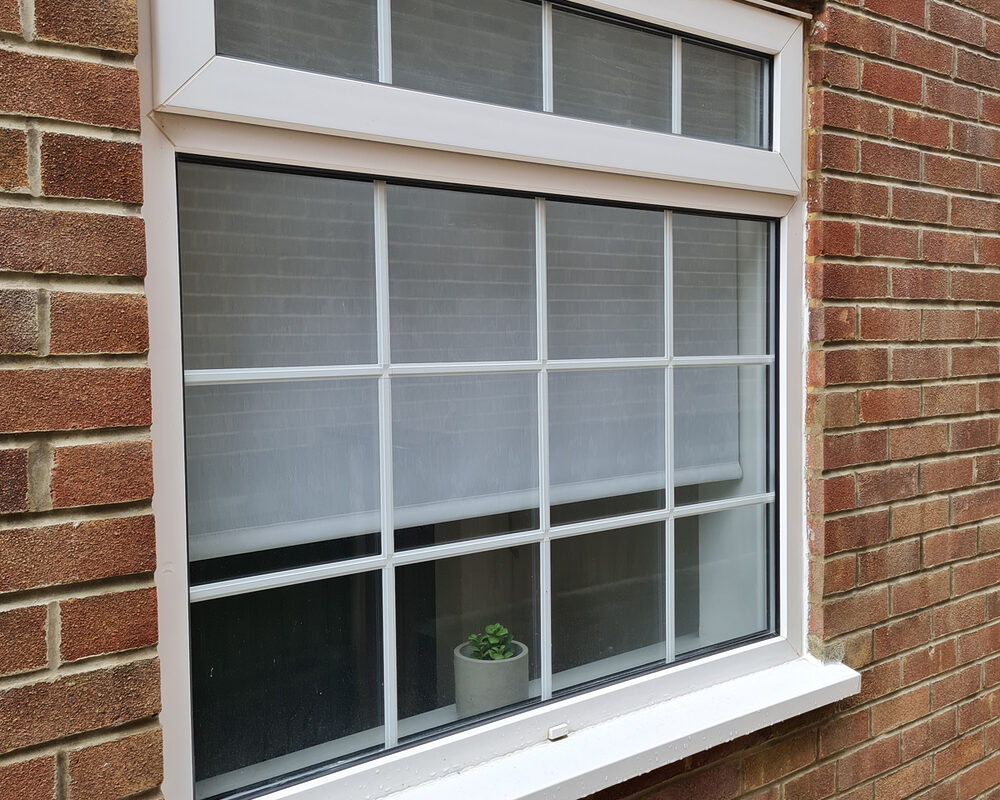 White UPVC Casement window with top leaf & astragal bars installed by River.ODP builders in Frimley in Surrey