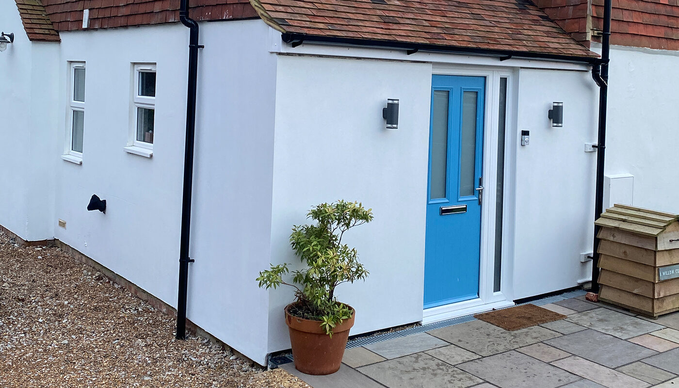 New white painted Porch with blue front door in Magham Down built by River ODP - building company.