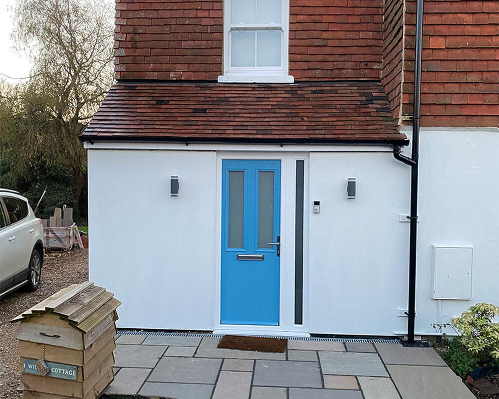 New white painted Porch with blue front door in Magham Down built by River ODP - building company.