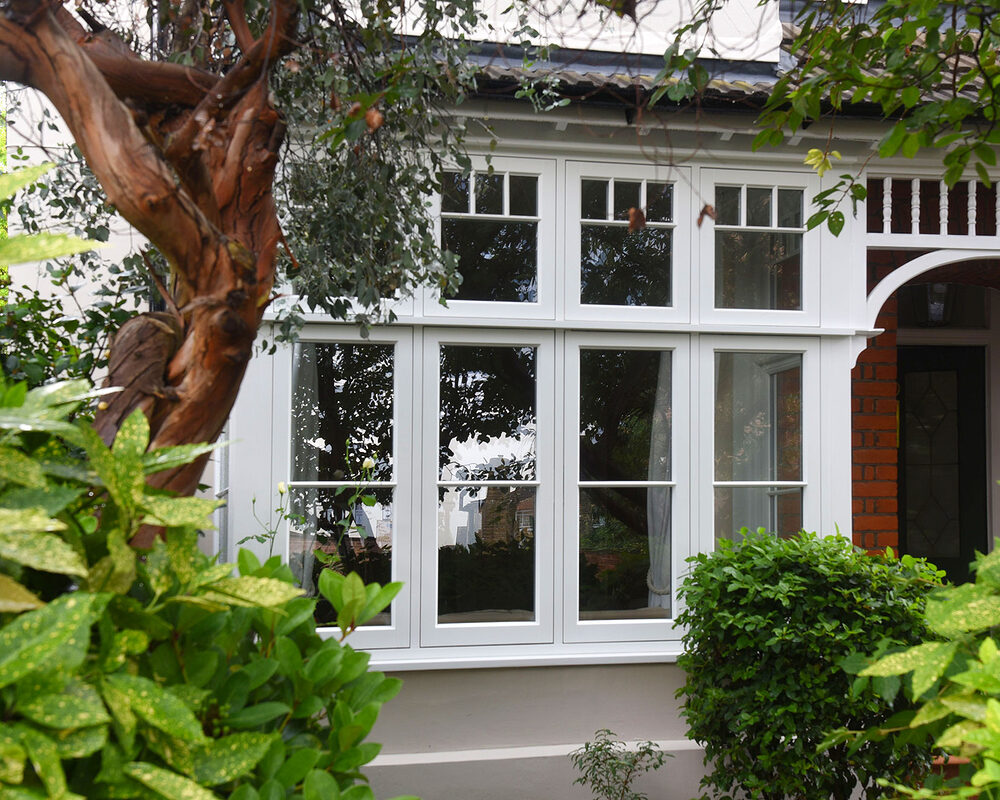 Flush casement windows with astragal bars mounted in Sussex house.