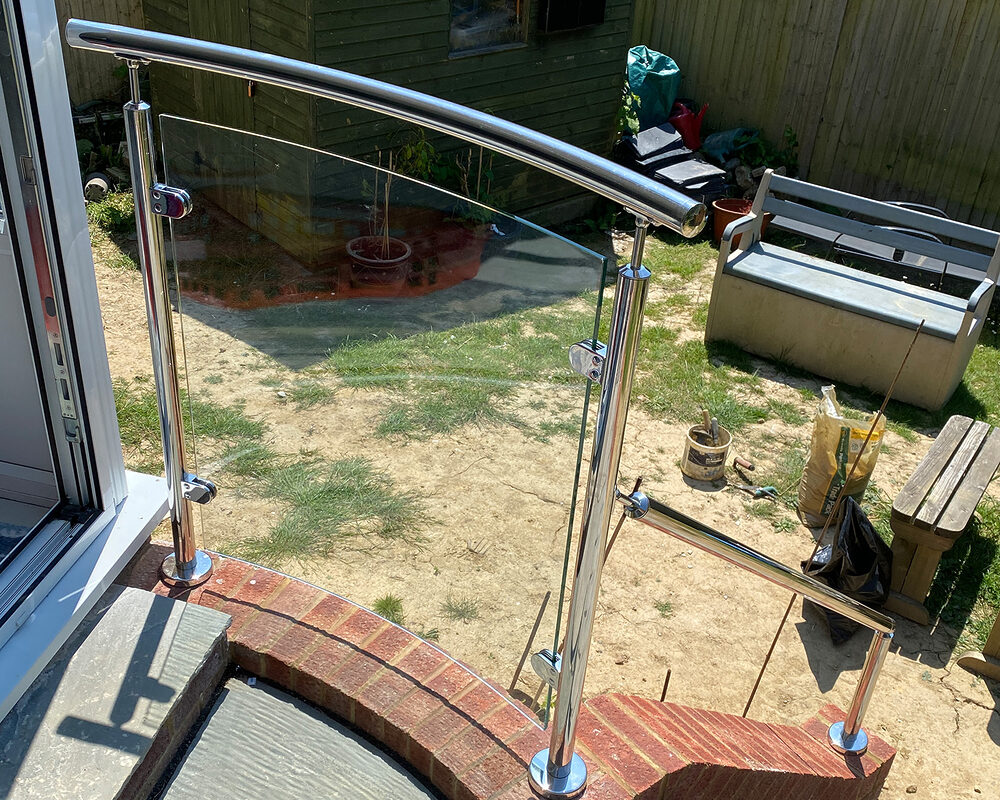 Glass panel installed between stainless steel balustrade posts in Henfield by River.ODP, professional installers and builders.
