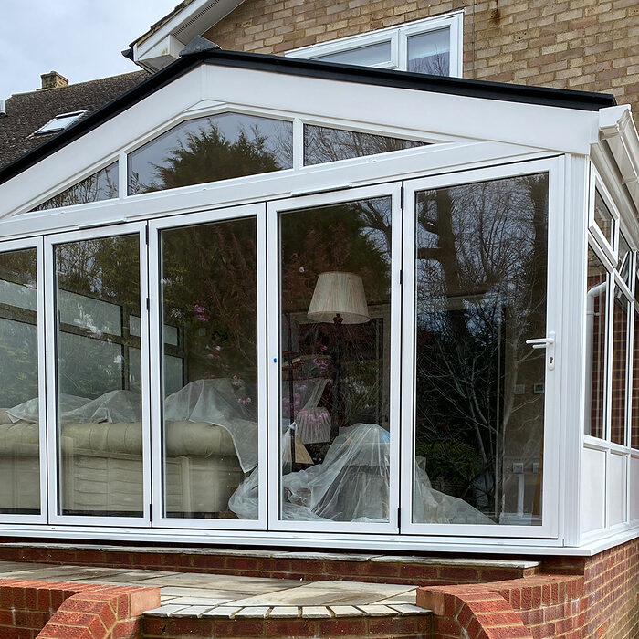 Edwardian style white uPVC conservatory with wide bi-folding doors during the construction by River.ODP building company in Bexhill, East Sussex.