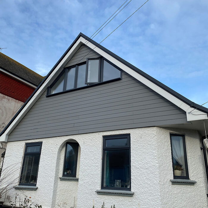 Modern Casement windows in anthracite colour installed in house with composite cladding by builders from River.ODP in Horley.