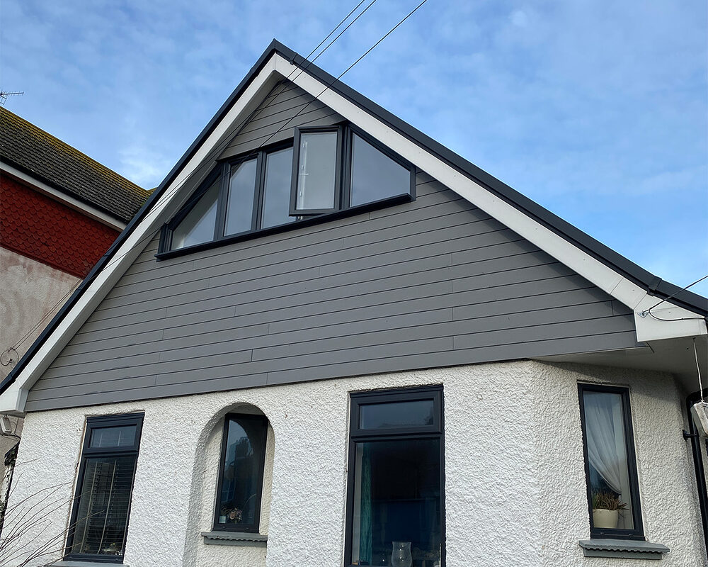 Modern Casement windows in anthracite colour installed in house with composite cladding by builders from River.ODP in Horley.