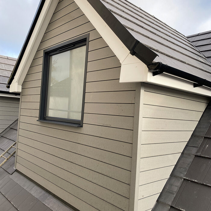 Modern gable roof extension with a single casement window in a sleek grey frame, installed by building company River.ODP in Staines.