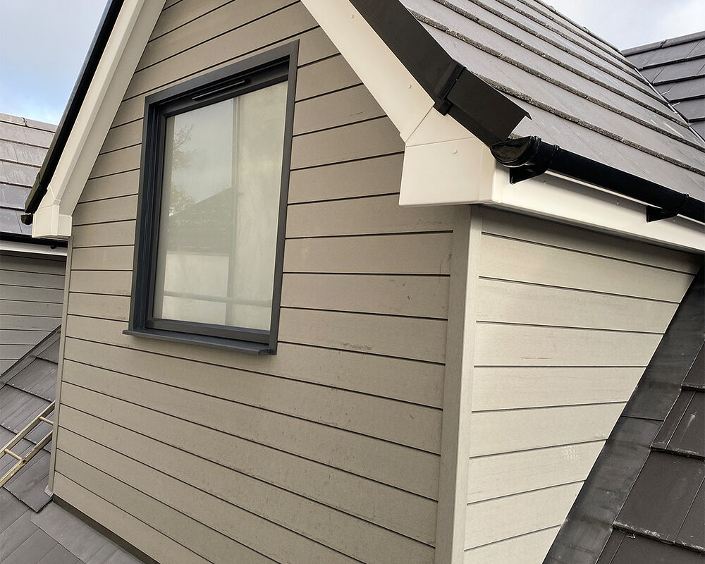 Modern gable roof extension with a single casement window in a sleek grey frame, installed by building company River.ODP in Staines.