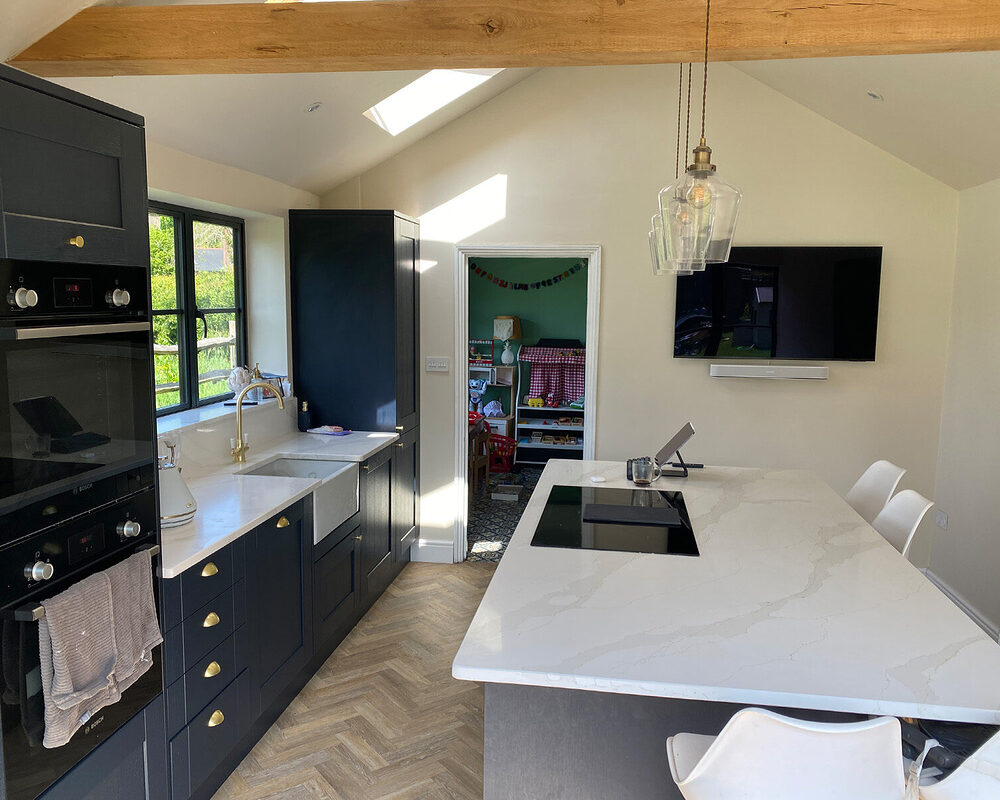 Marine blue kitchen with quartz worktop in Sevenoaks installed by professional kitchen installers from building company.