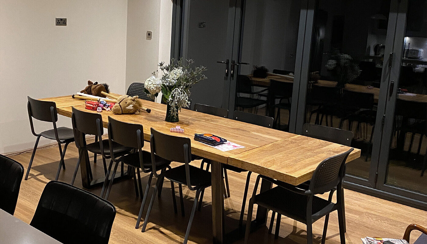 Dining area with wooden table in kitchen extension built by builders from building company River.ODP in Eastbourne.