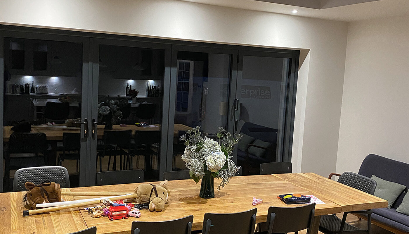 Dining area with wooden table in kitchen extension built by builders from building company River.ODP in Wadhurst.