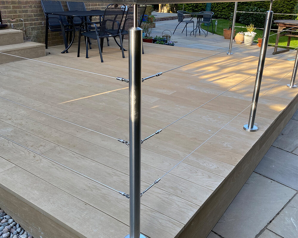 Modern stainless steel balustrade with a wired system installed on composite decking in Heathfield by Installation company River.ODP.