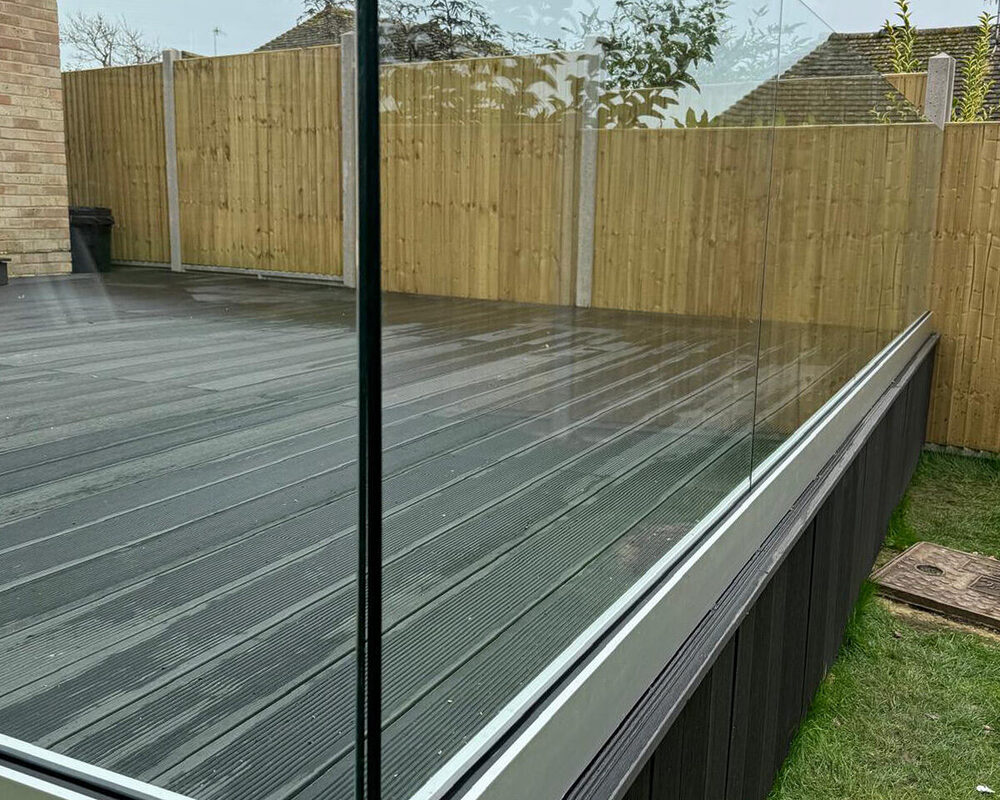 Frameless glass balustrade installation on composite decking in Dartford by building company River.ODP.