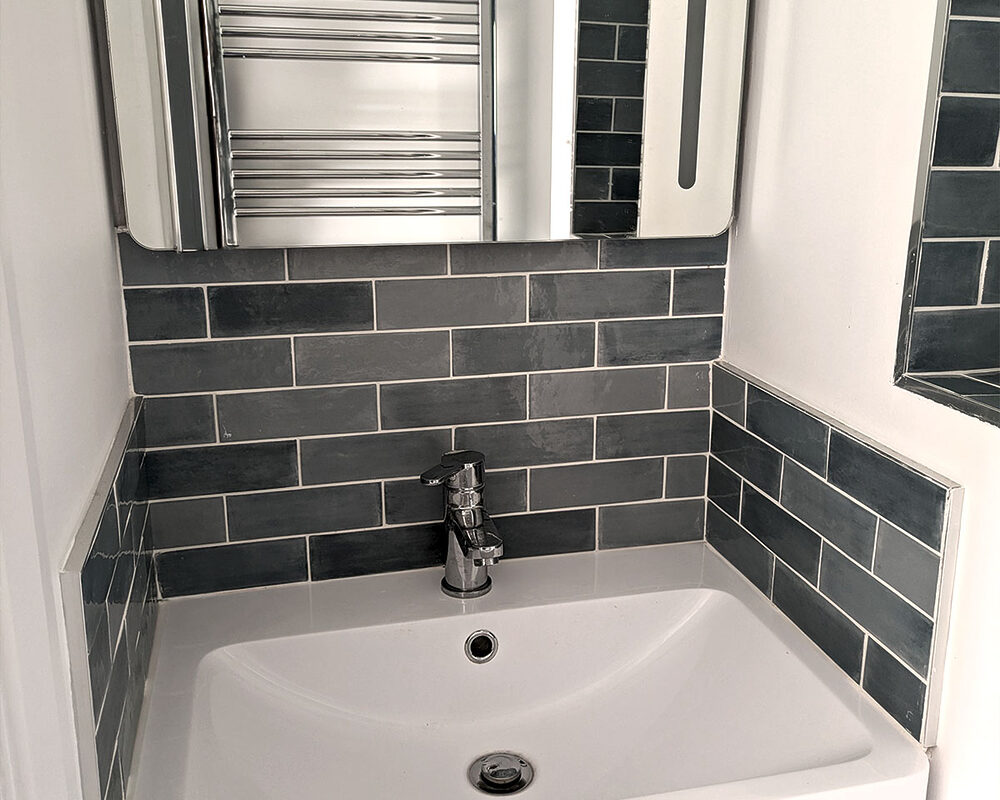 Compact bathroom sink with grey tile backsplash in Brighton by River.ODP, expert bathroom installers.