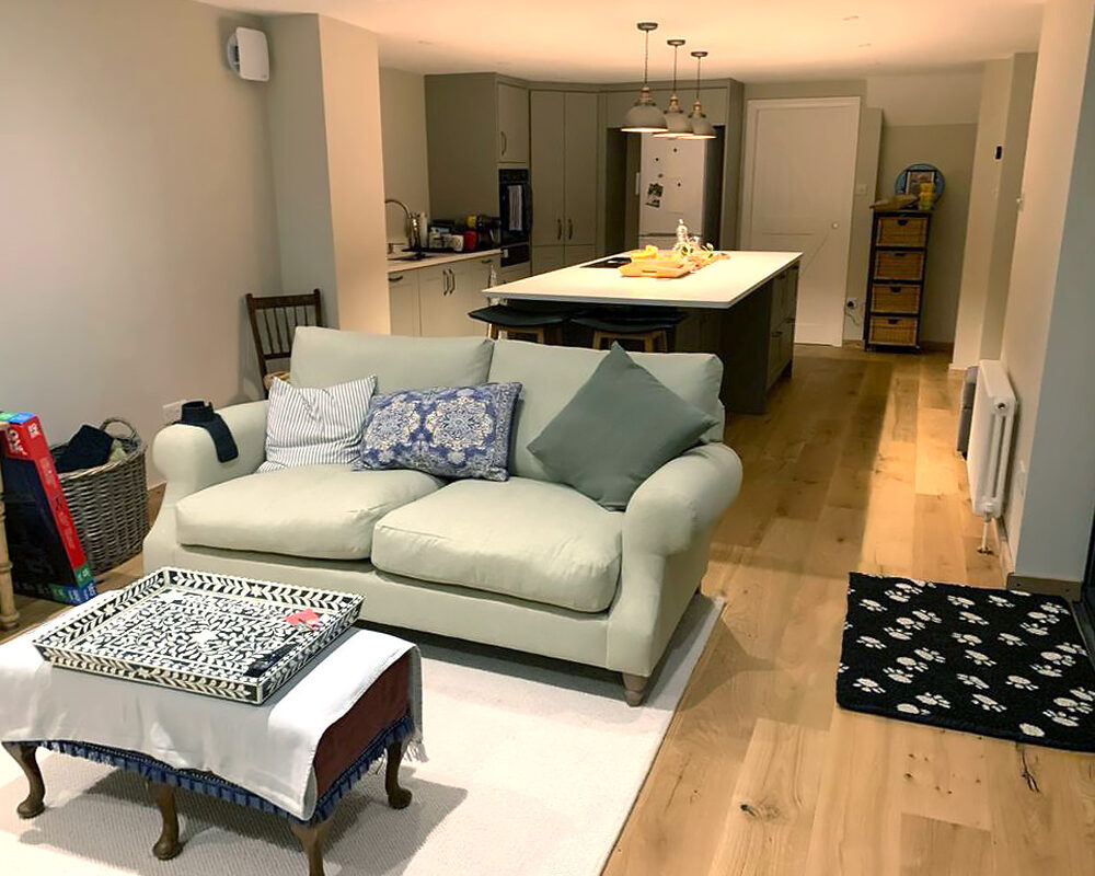 Open-plan view of living area and kitchen extension fitted in Shoreham by Sea by installers and builders from River.ODP building company.