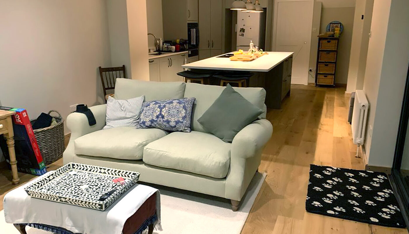 Open-plan view of living area and kitchen extension fitted in Shoreham by Sea by installers and builders from River.ODP building company.