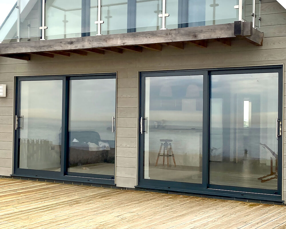 Two aluminium sliding patio doors in anthracite colour installed by River.ODP in Normans Bay, Eastbourne.