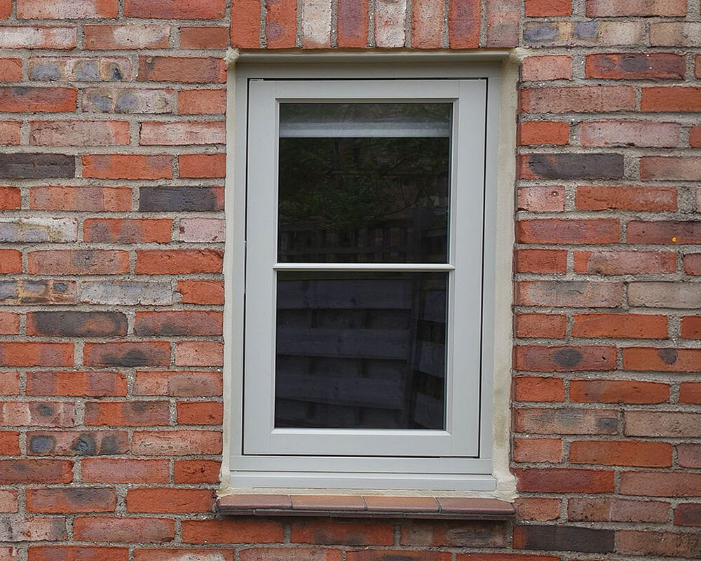 Timber flush casement window with astragal bar mounted in West Sussex house by River ODP -building company