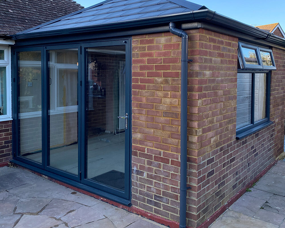 Old Conservatory was changed to modern orangery extension with anthracite windows and bi-folding patio doors. River.odp
