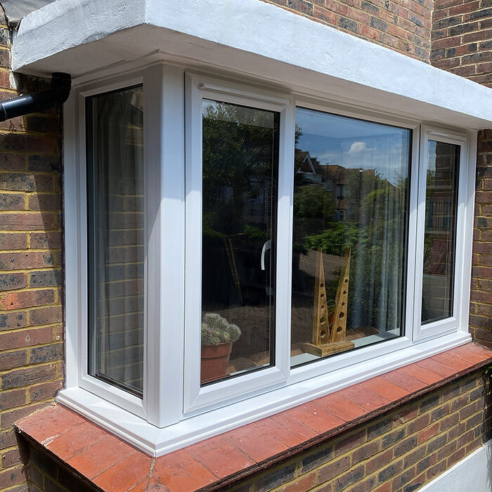 White UPVC Casement bay window installed by building company River.ODP in Dorking in Surrey .