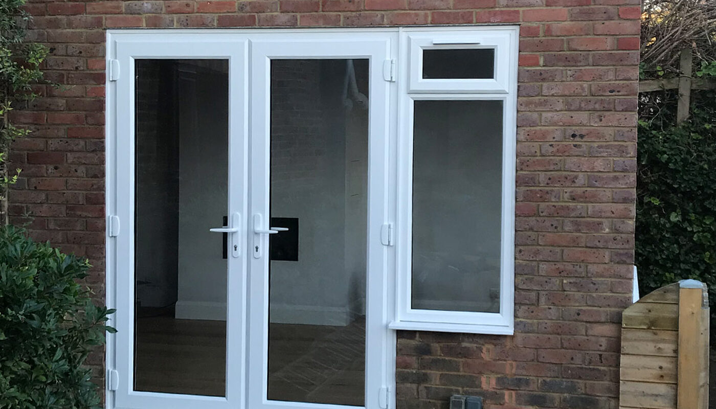 Old conservatory was replaced to new house extension with white French patio doors and UPVC windows in house in Eastbourne
