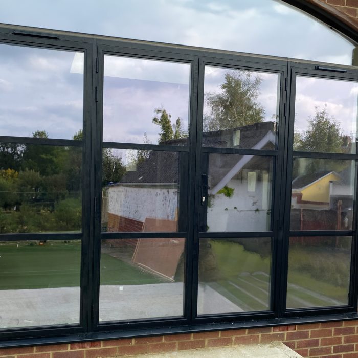 Aluminium French doors with windows on both side in shaker style in the new extension installed by Building company River.ODP in East Sussex