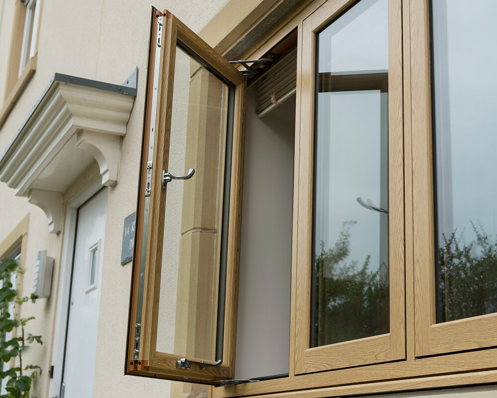 Modern flush windows have been opened to showcase the high quality locking system & teardrop handle installed in East Sussex