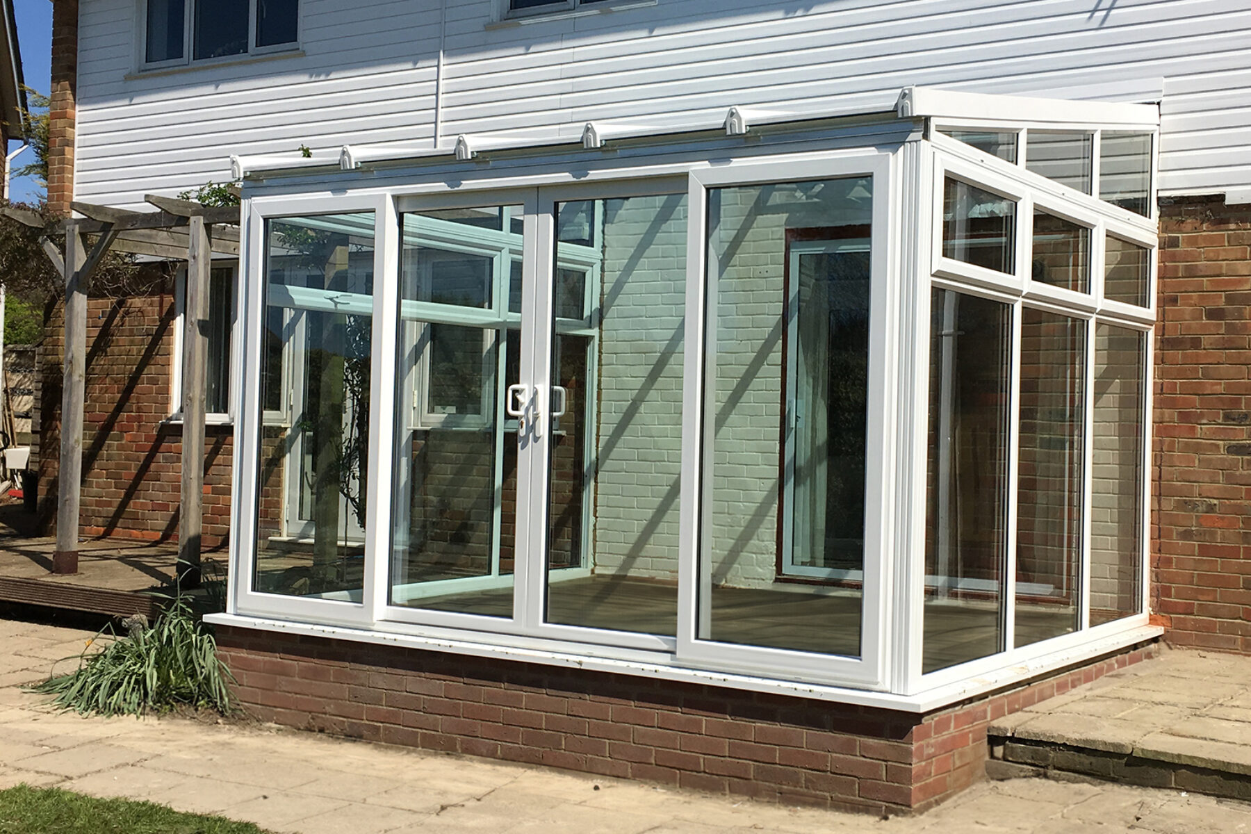 White uPVC Lean-to conservatory designed and constructed by the building company River.ODP in Seaford, East Sussex