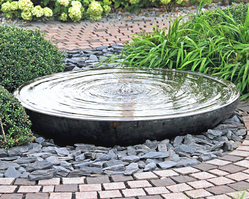 Large water bowl with vertical spout installed in garden in East Sussex by River ODP
