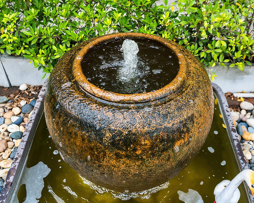 Water jug with vertical spout installed in garden in West Sussex by River ODP