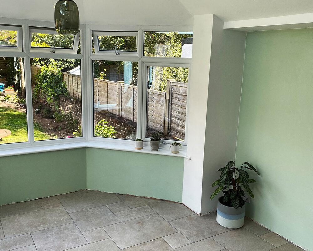 Just painted walls and ceiling of a Victorian conservatory with double glazed casement windows and warm roof in Eastbourne.